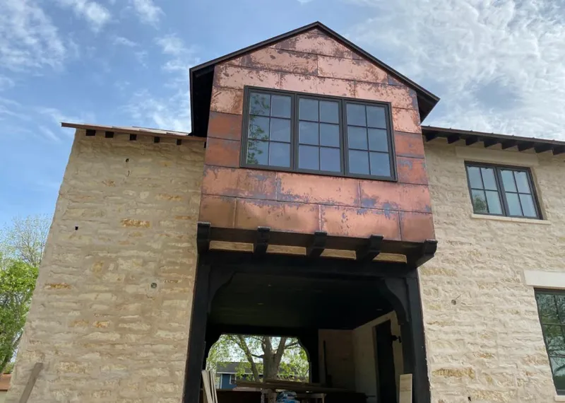 Copper metal panel facade on a stone building for Metal Roof Coating in Cheney